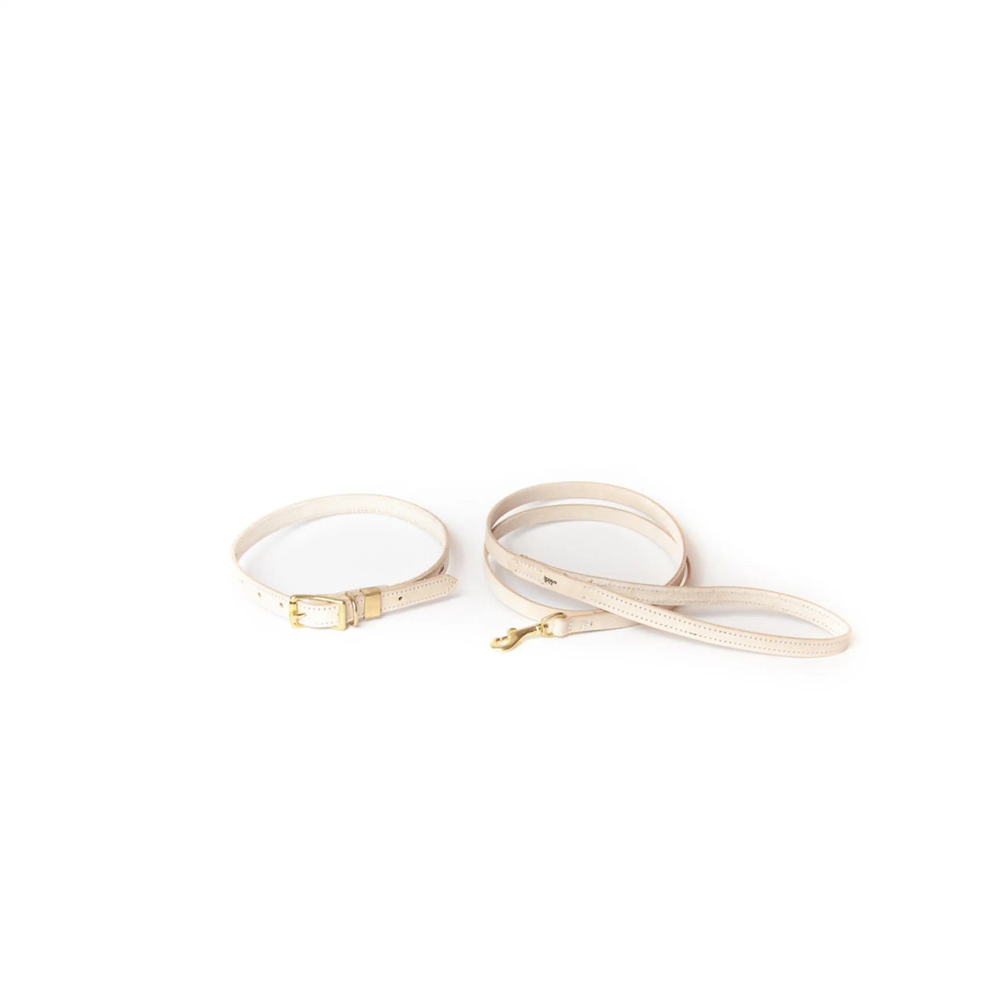 Beige handbag strap with gold hardware on a white background