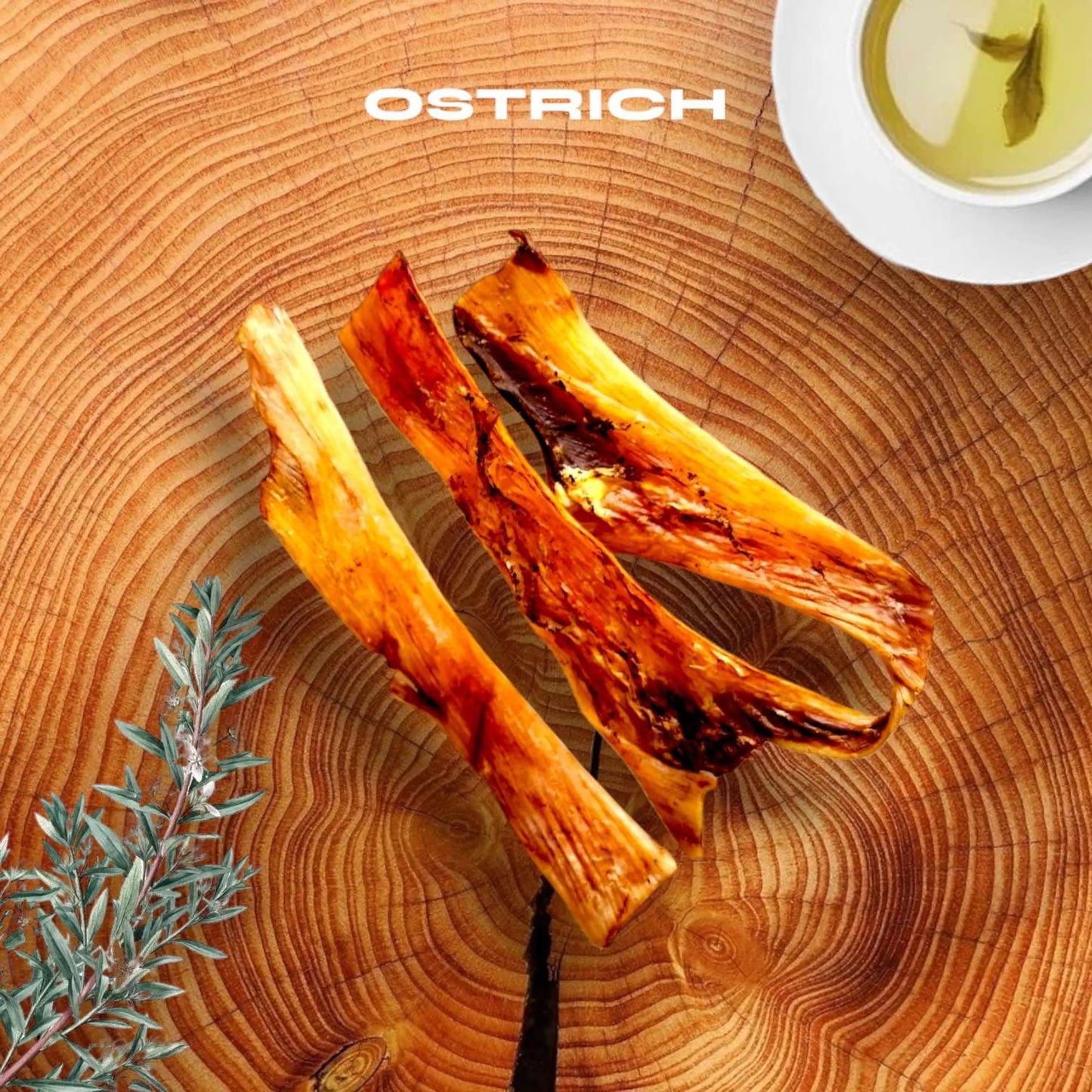 Two roasted lamb chops on a wooden cutting board with 'Ostrich' branding.
