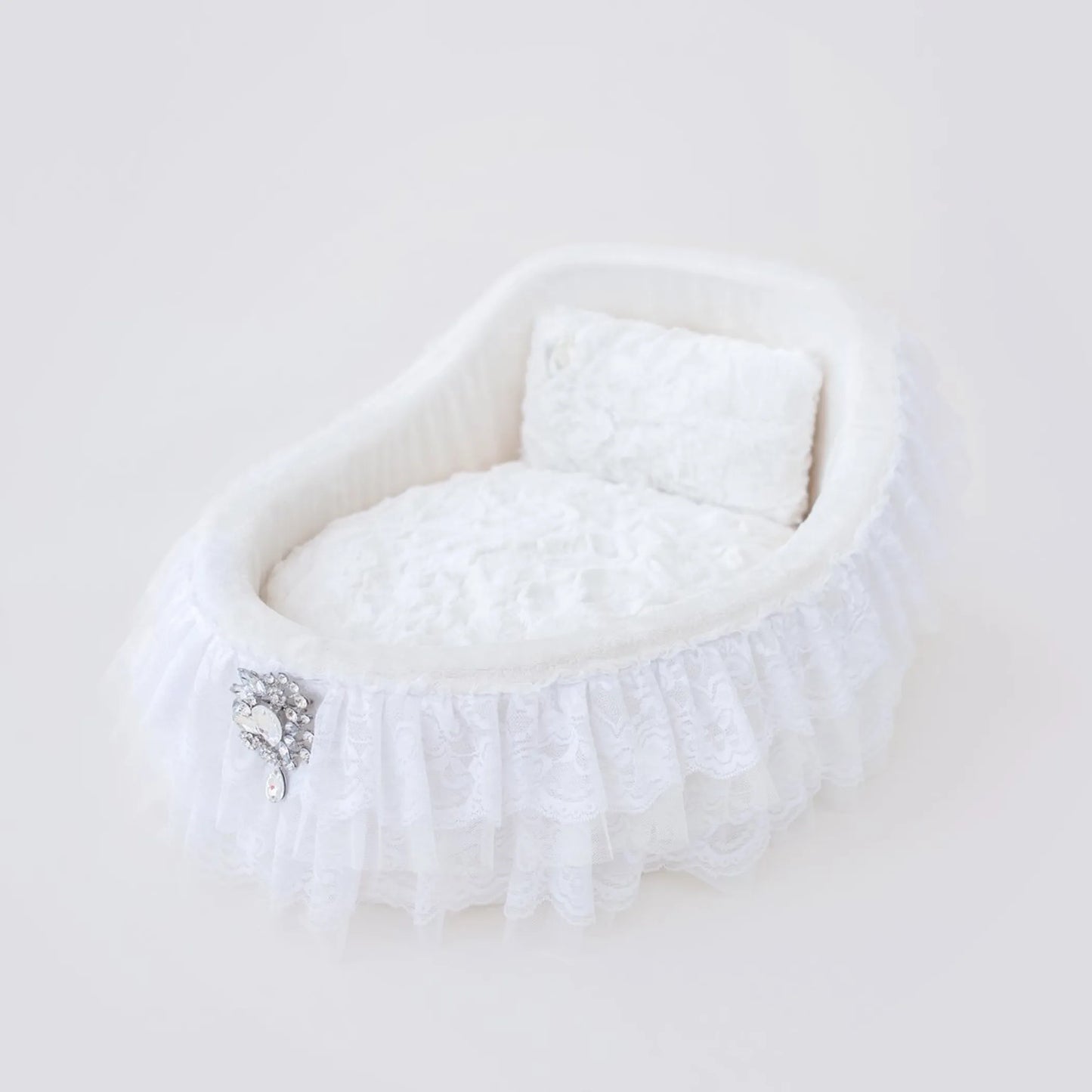 White fur stole with a decorative brooch on a light background