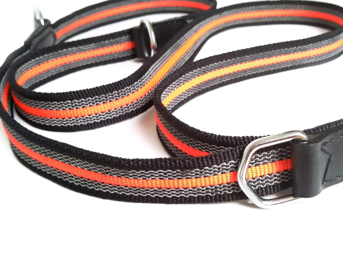 Dog leash with black, orange, and gray stripes on a white background