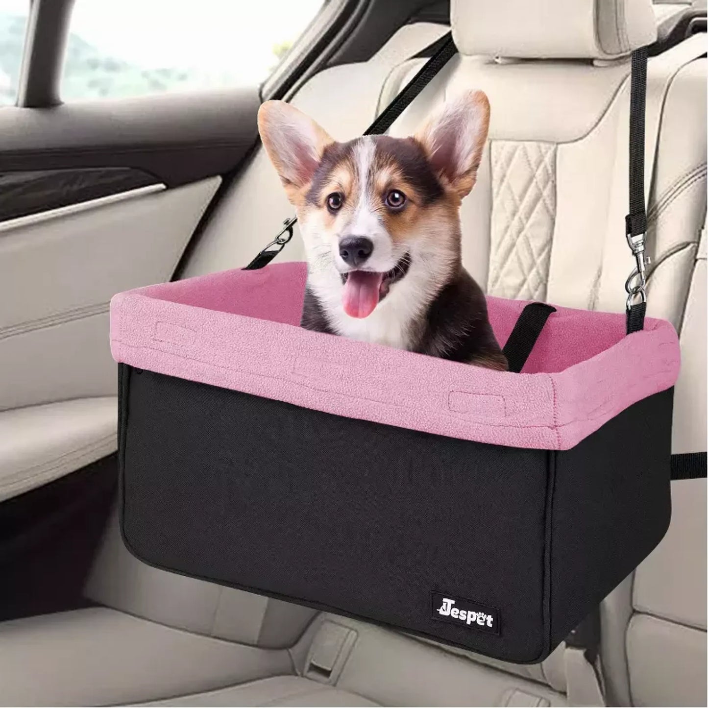 Dog in a pink and black pet seat in a car