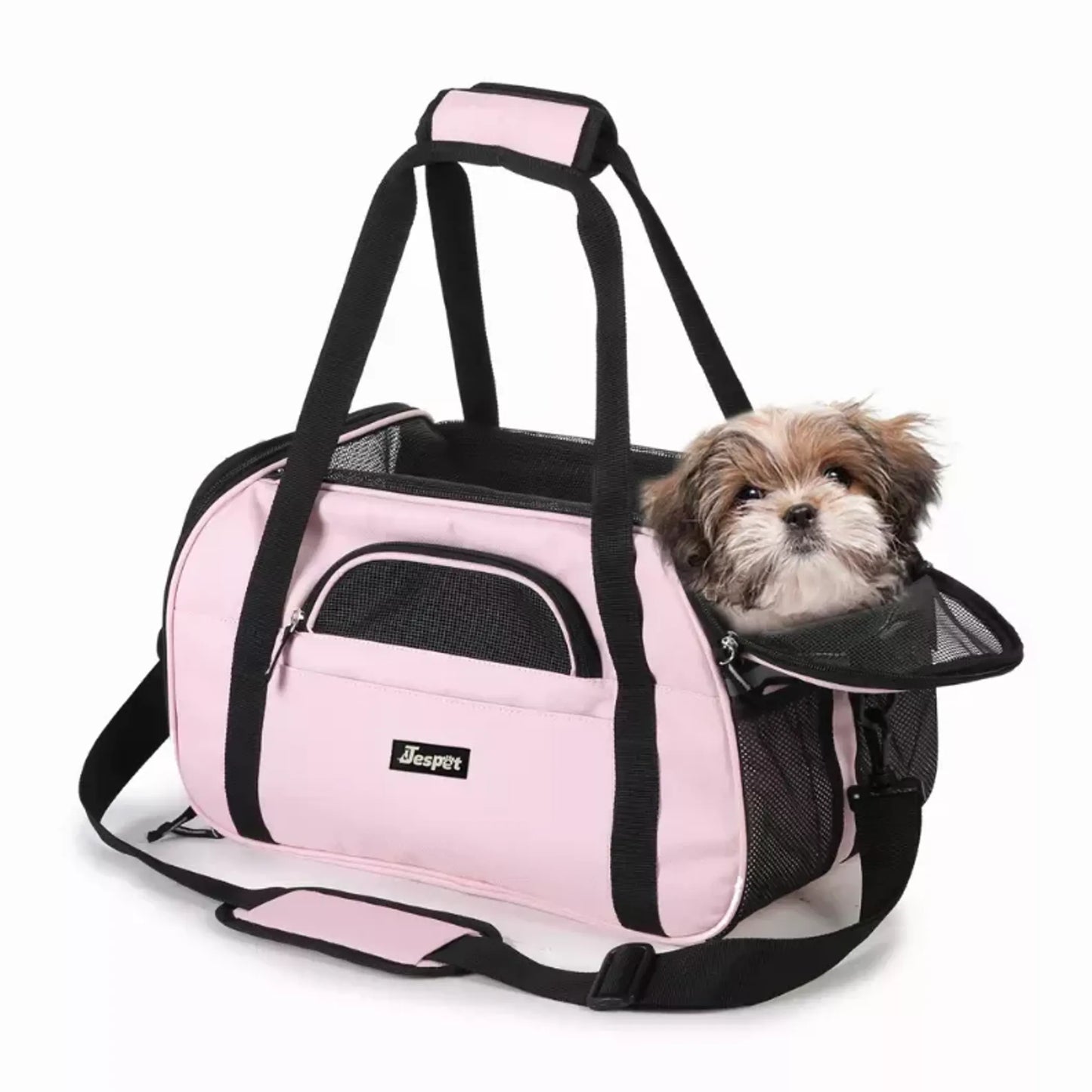 Pink pet carrier with a small dog peeking out on a white background