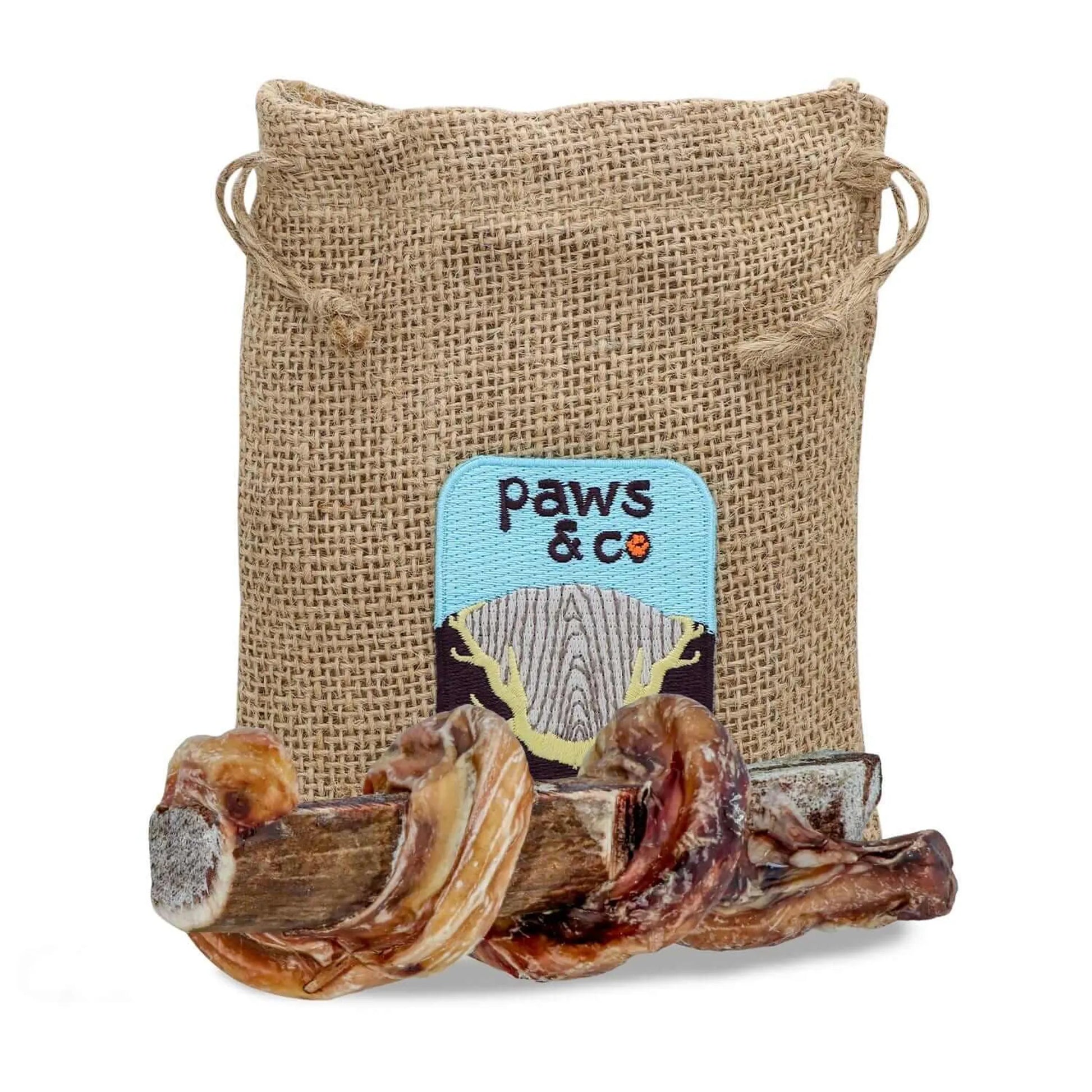 Dog chew treat in a 'paws & co' branded burlap bag on a white background