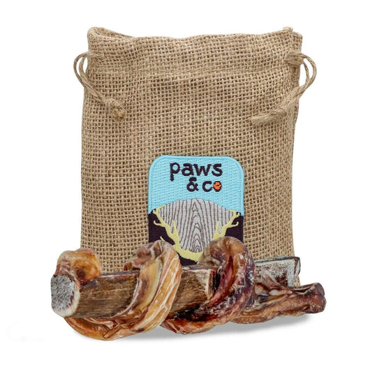 Dog chew treat in a 'paws & co' branded burlap bag on a white background