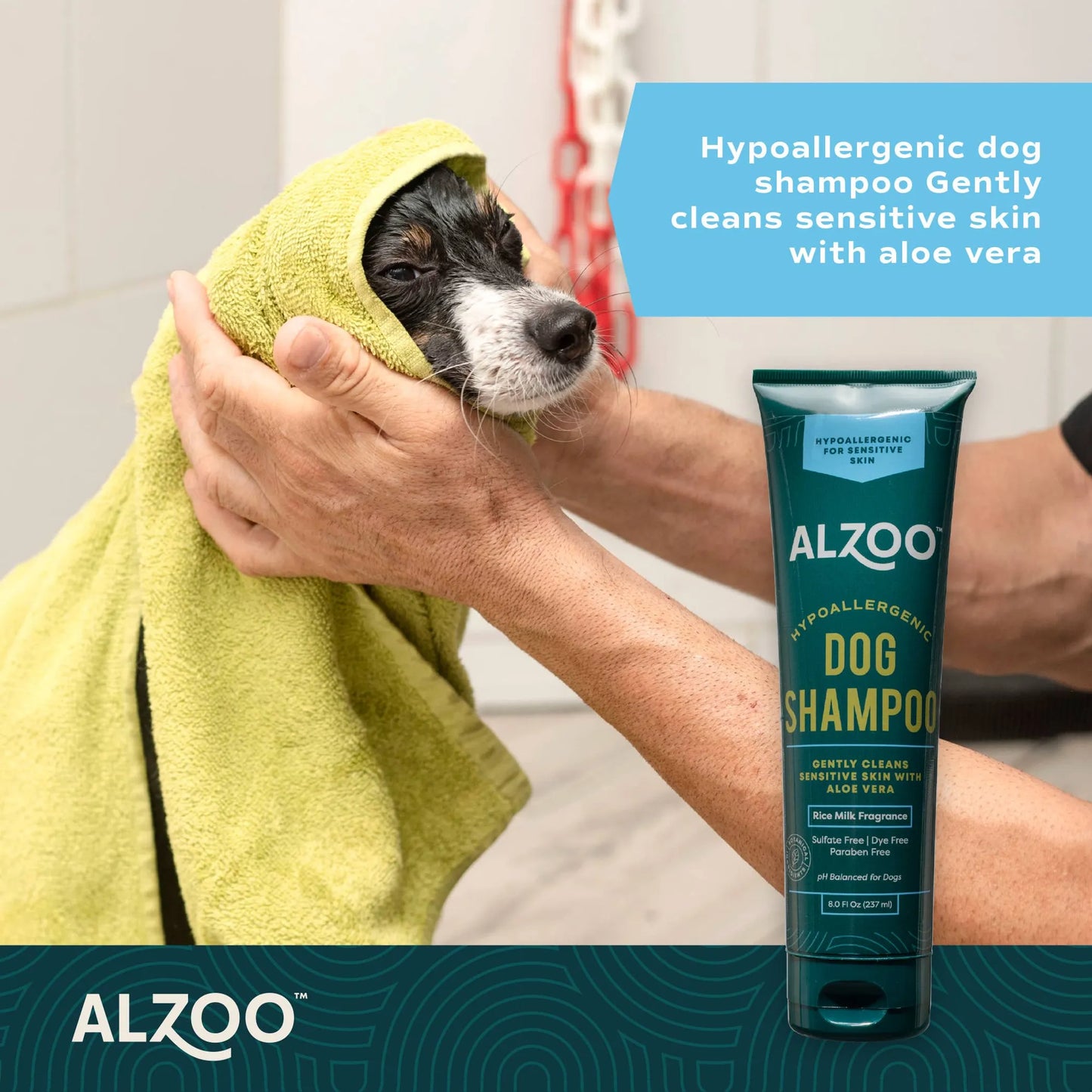 Dog being dried with a towel, holding ALZOO dog shampoo bottle.