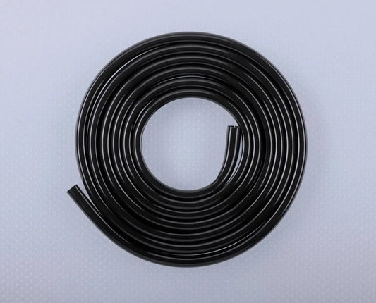 Coiled black rubber strip on a light gray background