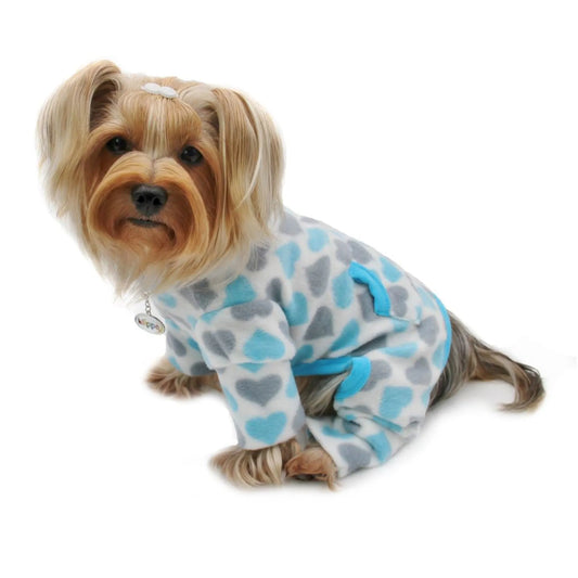 Dog wearing a blue and gray patterned onesie on a white background