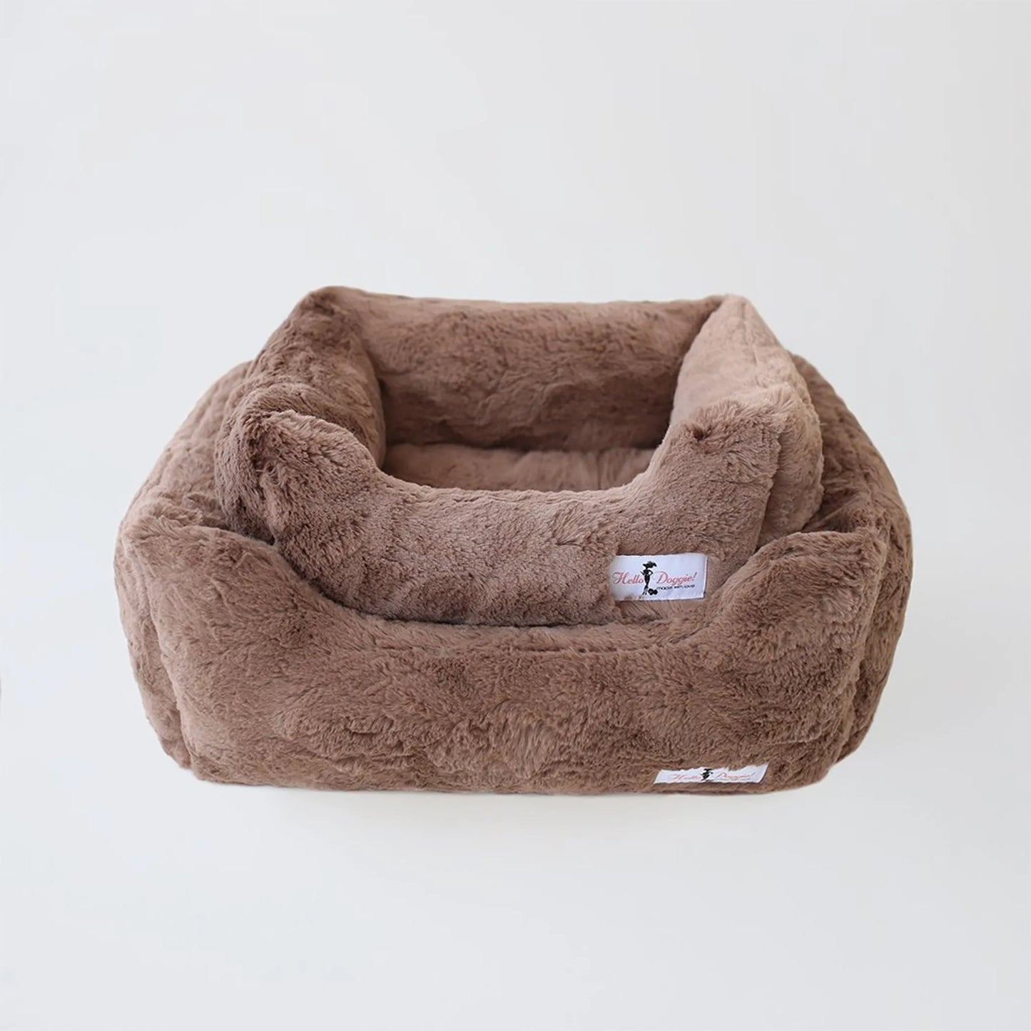 Brown plush pet bed with a visible brand label on a white background