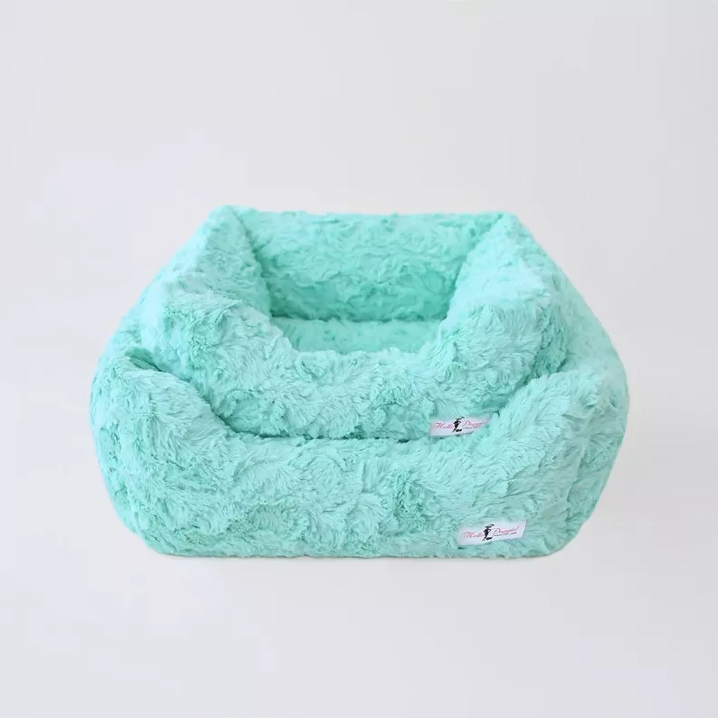 Mint green fluffy pet bed on a light gray background