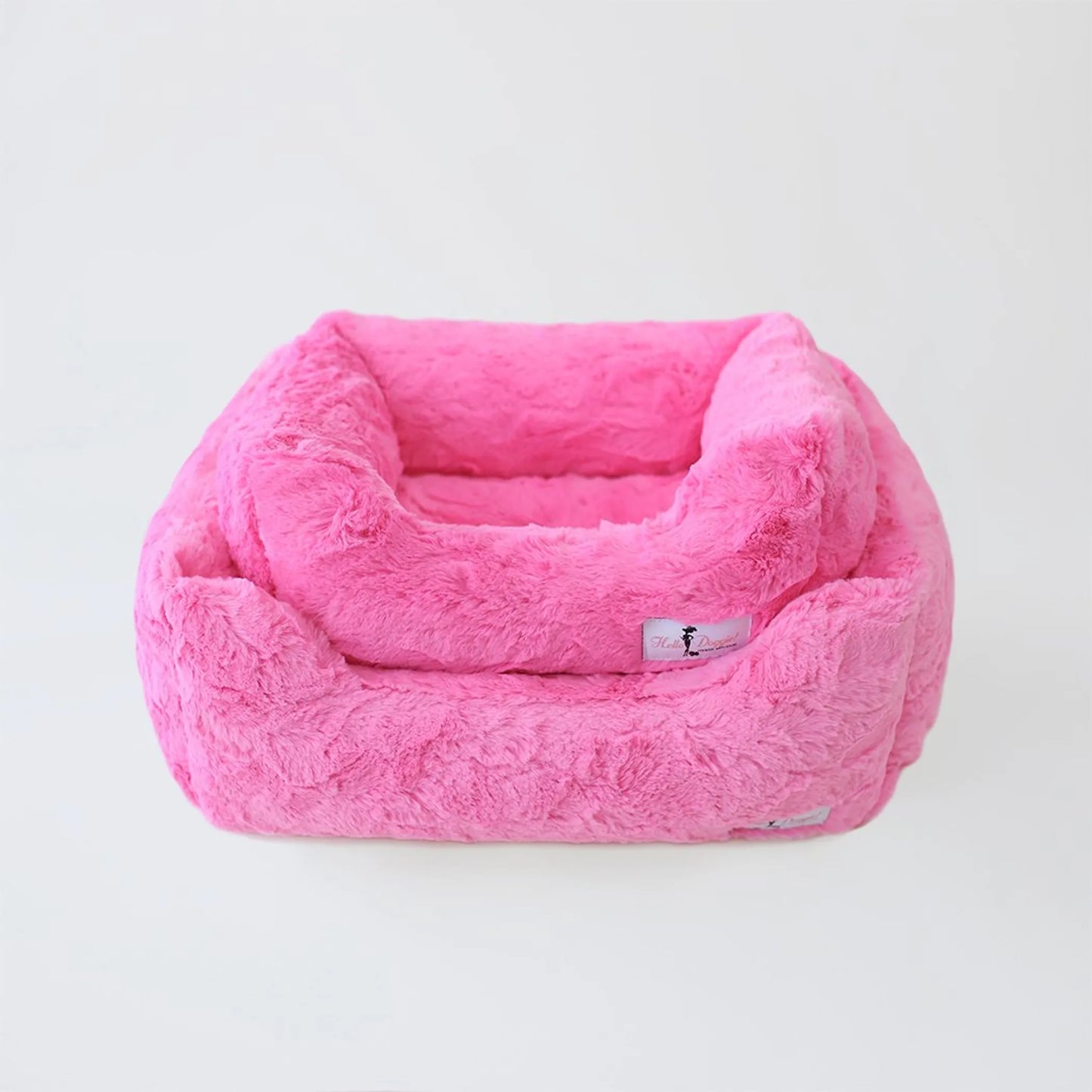Pink plush pet bed on a white background