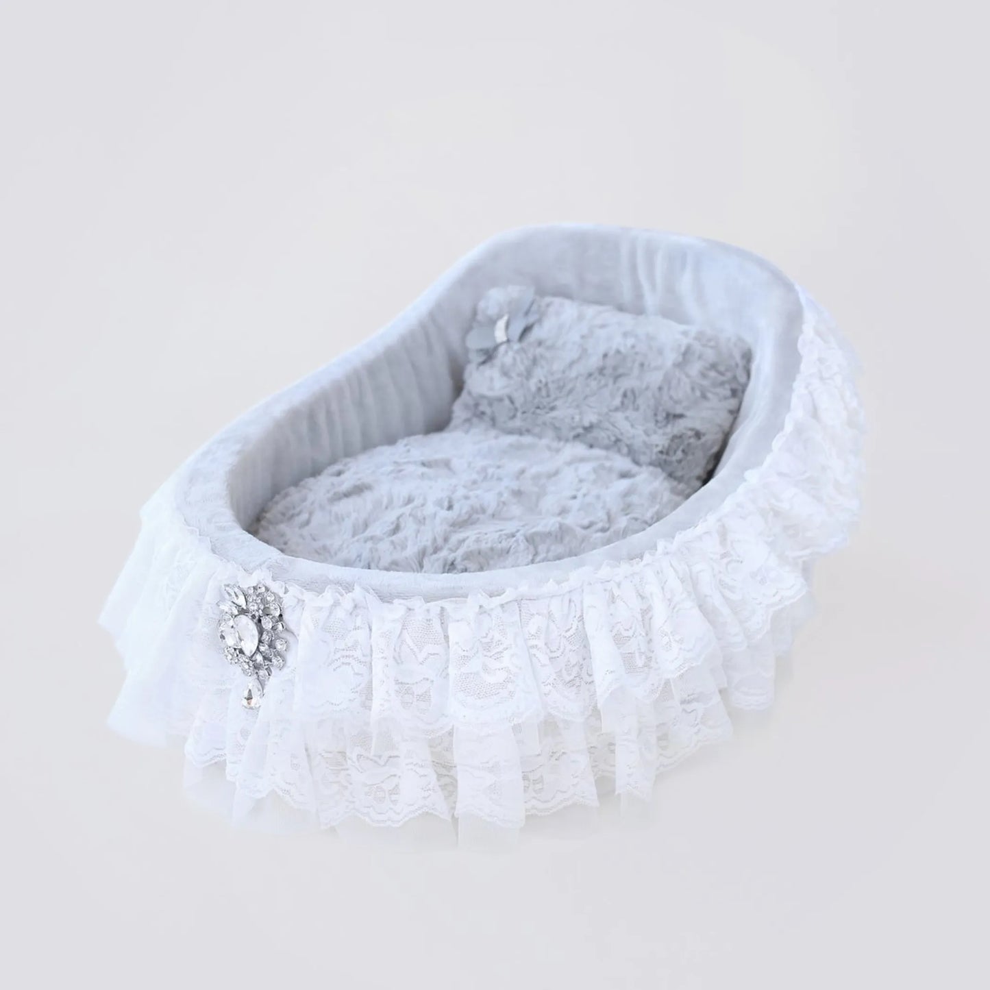 White pet bed with lace trim and decorative stones on a light gray background