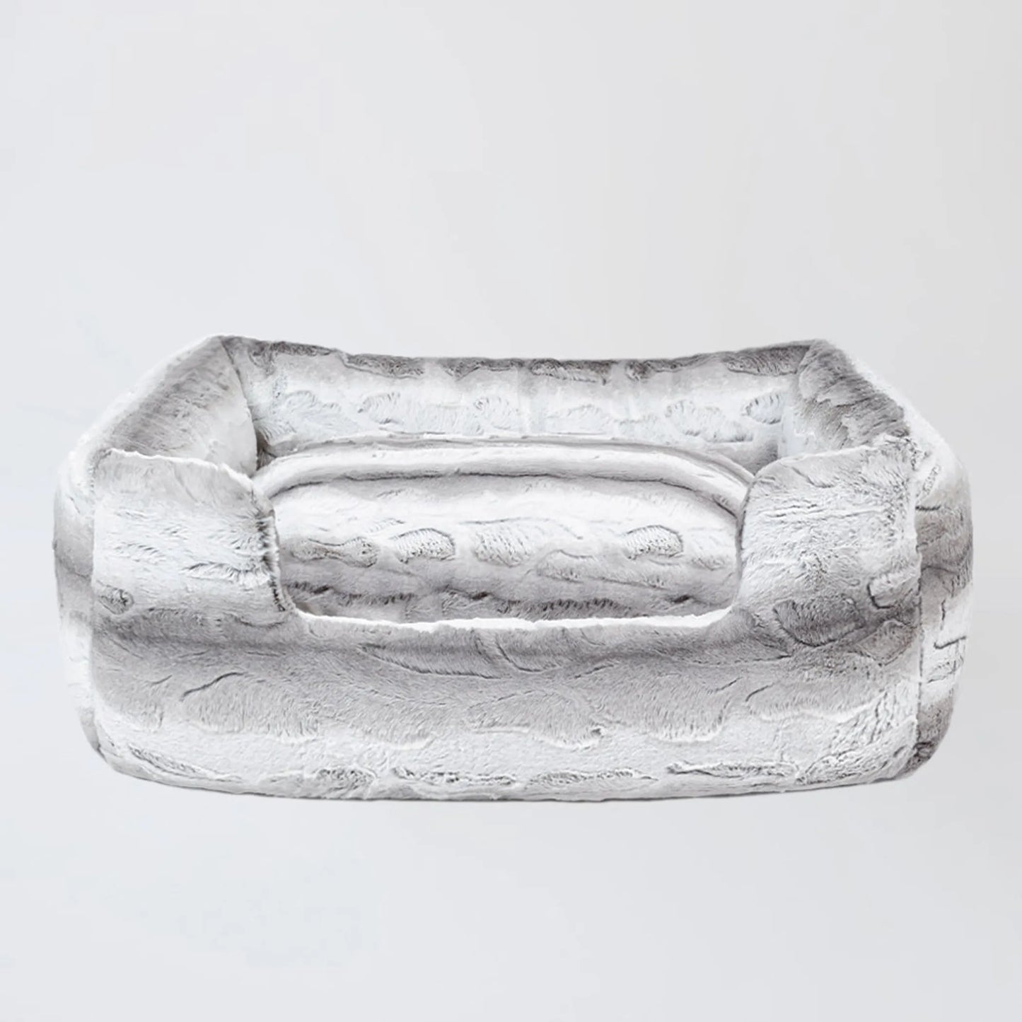 Rectangular stone object with a handle on a light gray background