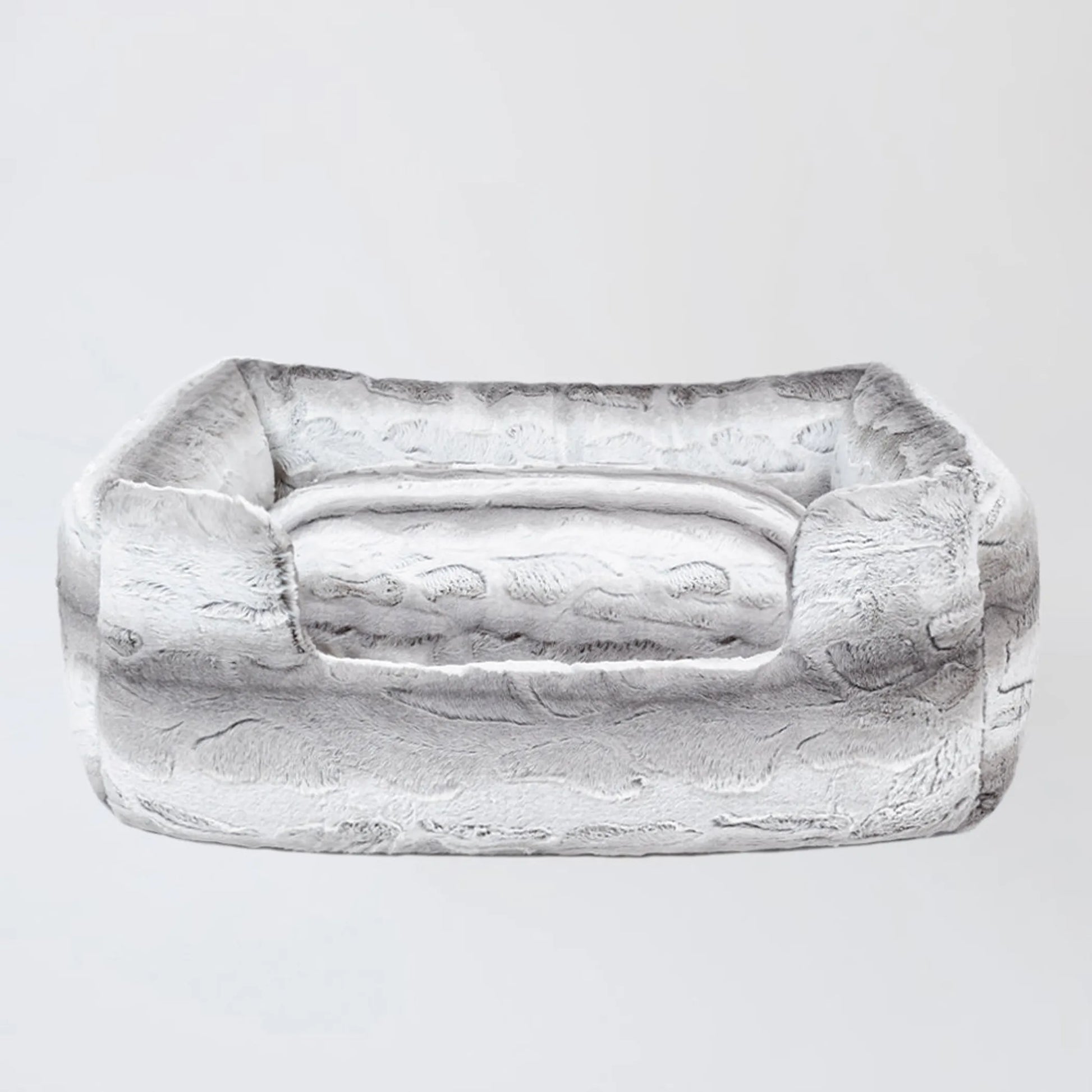 Rectangular stone object with a handle on a light gray background