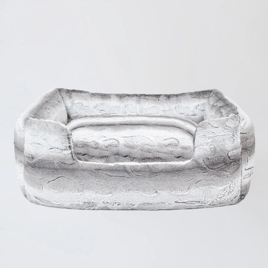 Rectangular stone object with a handle on a light gray background