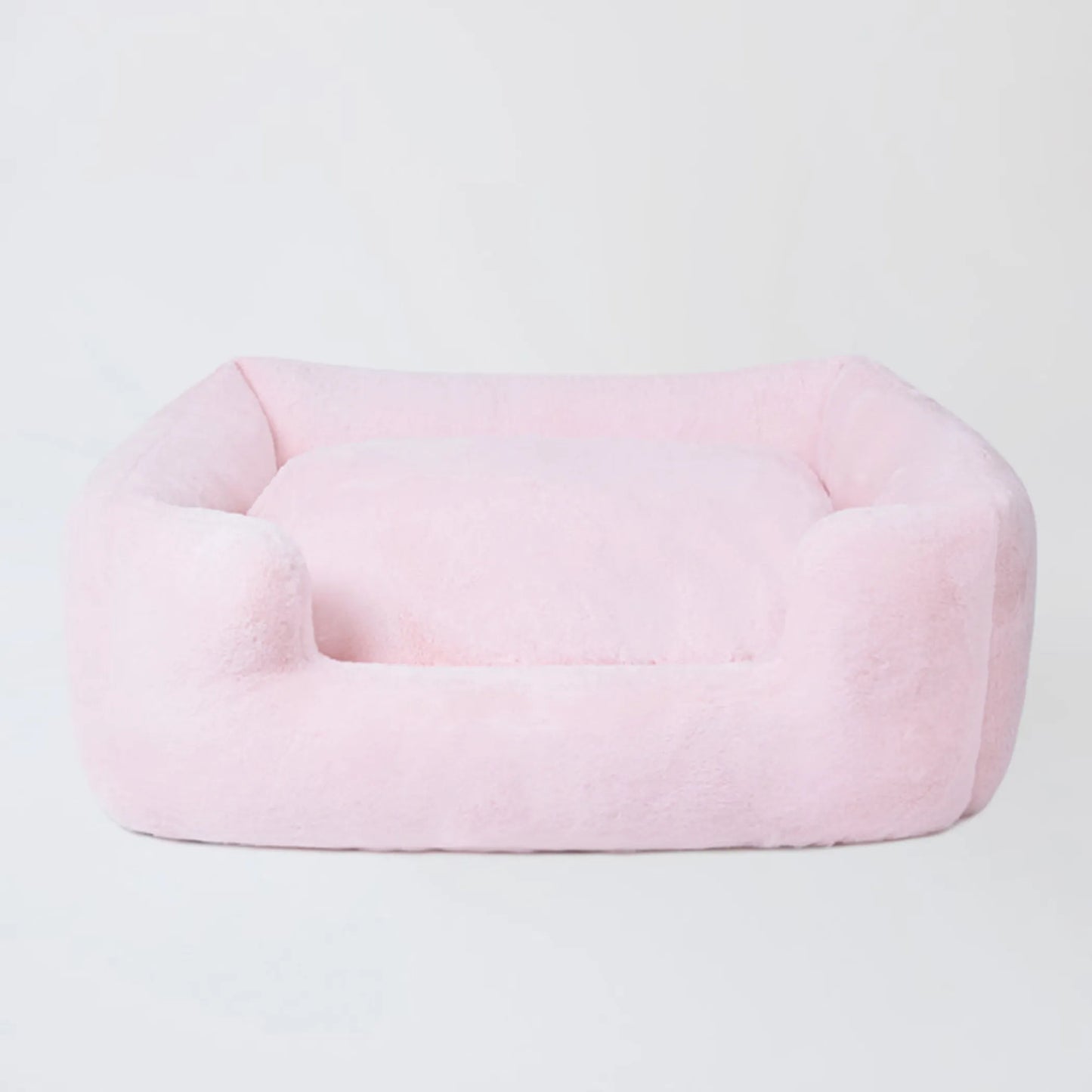 Pink pet bed on a light gray background